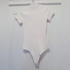 Womens Abercrombie ribbed white bodysuit size small with small black mark on it
